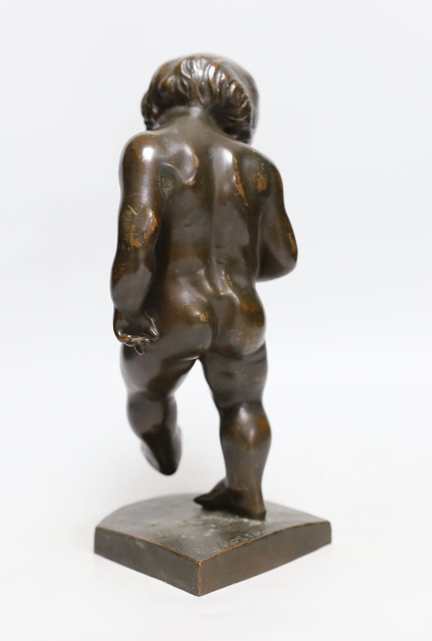 A bronze cherubic boy, signed J. Kostiak, 26cm high